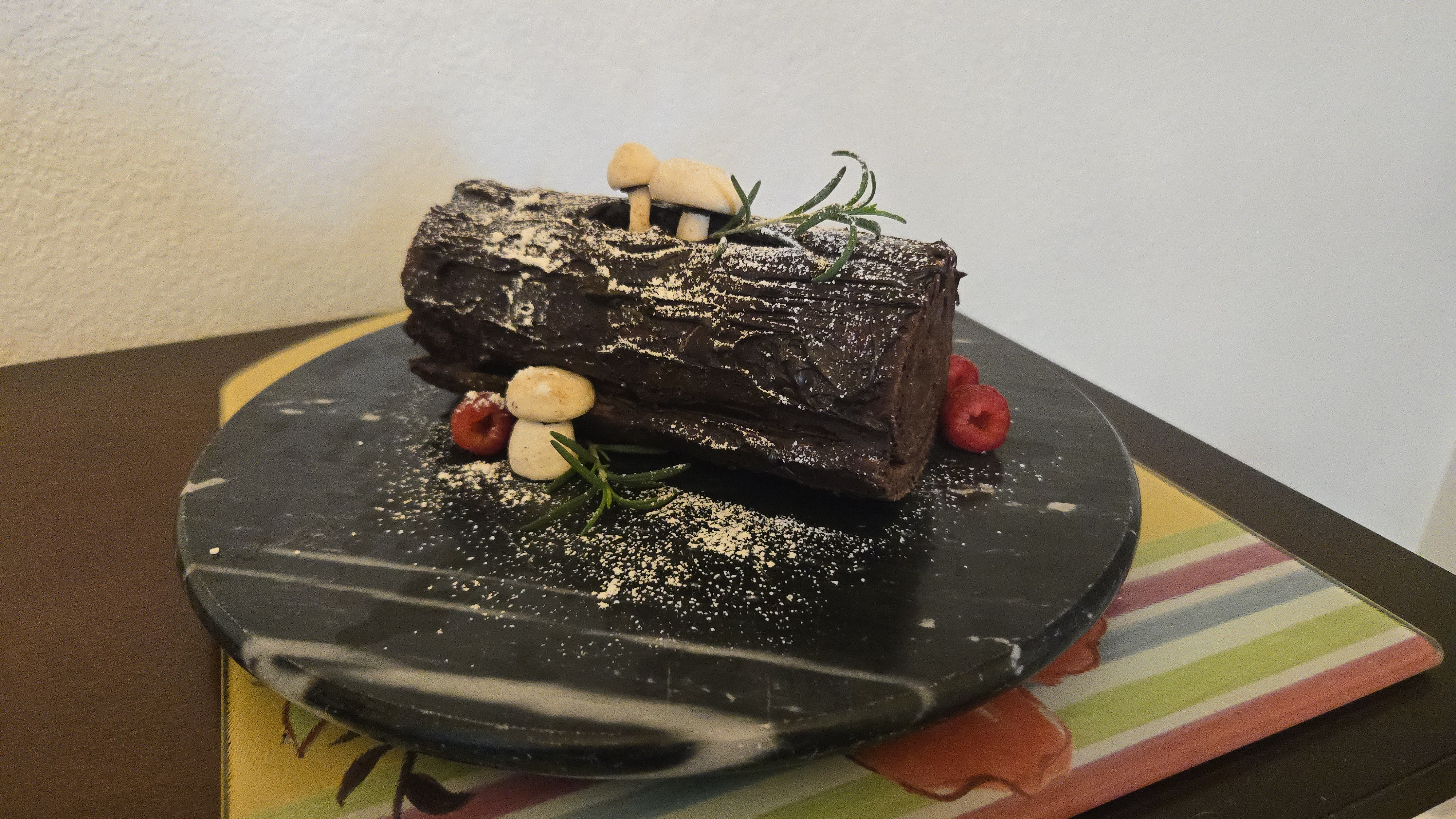 Dark chocolate log cake with mushrooms and rosemary